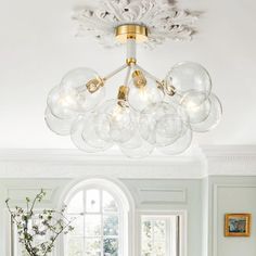 a dining room table with chairs and a chandelier in the middle of it