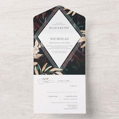 a wedding card with an elegant floral design on the front and back, in black and white