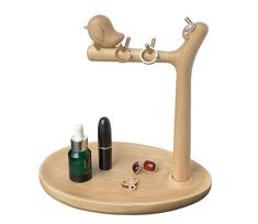 a wooden stand with two bottles and a small bird on the top one is filled with nail polish