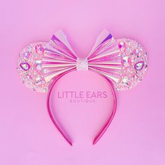 a pink minnie mouse ears headband with swarongs on it and the words little ears boutique