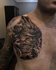 a man with a tattoo on his chest