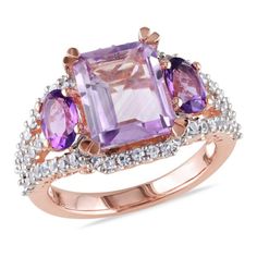 This stunning 3-stone multi-color engagement ring is crafted in rose gold plated sterling silver and features a single emerald-cut dazzling rose de france (3.13 ct. T.W.) at the center and secured with two oval-cut amethyst-africa (0.9 ct. T.W.). Further, the ring is enhanced with 62 round-cut sparkling (0.62 ct. T.W.) white sapphires set on its band. White Sapphire Ring, 3 Stone Rings, Men Ring, Zircon Ring, Sapphire Stone, Gold Plated Rings, White Sapphire, Amethyst Ring, Gold Plated Sterling Silver