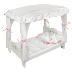 a white canopy bed with pink bows on the headboard and foot board, in front of a white background