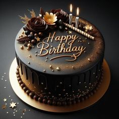 a chocolate birthday cake with lit candles on top