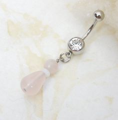 Belly ring features a smooth rose quartz gemstone teardrop accented with milky white opalite rondelle and faceted rose quartz.  Belly ring measures 2 inches long total length.  Barbell is 14g surgical steel with a 7/16" (11mm) wearable bar length. For Belly Button Rings: https://www.etsy.com/shop/AllAboutClass?section_id=18474235&ref=shopsection_leftnav_1  All body jewelry sales are final!!  AllAboutClass DOES NOT accept any returns on body jewelry for sanitary reasons. This is a standard policy Button Rings, Belly Ring, Rose Quartz Gemstone, Milky White, Quartz Rose, Belly Rings, Body Jewellery, Belly Button, Body Jewelry