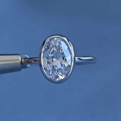 a close up of a ring with a diamond in it