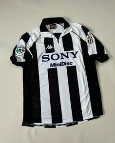 a black and white soccer jersey with the word sony on it's chest, hanging from a hanger