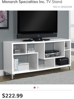 a flat screen tv sitting on top of a white entertainment center