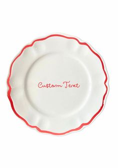 a white and red plate with the word custom text on it's center piece