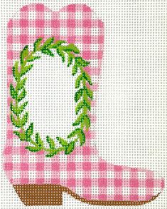 a pink cowboy boot with a green wreath on the front, and a white background