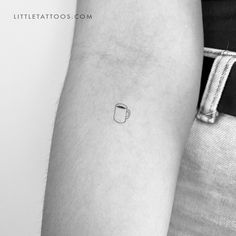 a small coffee cup tattoo on the arm