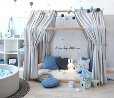 a child's bedroom decorated in blue and gray colors with toys on the floor