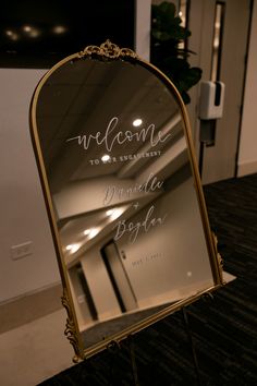 a welcome sign in front of a mirror