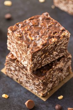 three pieces of chocolate peanut butter granola bars stacked on top of each other