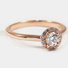 a rose gold engagement ring with an oval diamond center