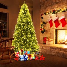 a lit christmas tree in front of a fireplace