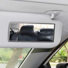 there is a car mirror in the side view mirror that shows it's interior