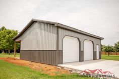 a two car garage with an attached carport on the side and one door open