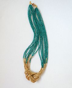 "This unique peacock green and gold necklace is a little more regal and elegant than my usual designs. The gold detail made with hexagon seed beads make the light reflect very nicely on the necklace. It closed with a gold clasp. It has 8 strands. Matching earrings sold here: https://www.etsy.com/listing/218792281/light-gold-beaded-earrings-gold Measures 18\"- ❤ PROCESSING AND SHIPPING Most orders are made and shipped out in one business day. Please check delivery timeframes for your location on Elegant Green Beaded Necklace With Tiny Beads, Elegant Green Beaded Necklaces With Gold Beads, Elegant Green Beaded Necklace With Gold Beads, Elegant Turquoise Beaded Necklaces With Gold Beads, Elegant Turquoise Beaded Necklace With Gold Beads, Elegant Multi-strand Necklace With Tiny Beads, Elegant Multi-strand Turquoise Beaded Necklaces, Elegant Necklaces With Tiny Beads For Festive Occasions, Elegant Festive Necklace With Tiny Beads