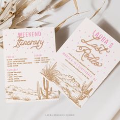 two pink and gold wedding stationery cards on top of a white table with feathers