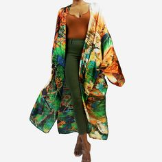 A light-weight long kimono with a luxurious, flowing drape French seam finish Side slits at hem Charmeuse satin, 22mm. Machine wash cold, gentle cycle, hang dry. The Jungle motif of this kimono offset by contrasting shades of sunset orange makes for an alluring combination.  Whether worn over a a tee and jeans, a matchy-matching co-ord set, or as a flowing swimsuit cover, this kimono is sure to turn heads and turn any regular outfit into a stunning showstopper! Kimono Size Measurements: * Should Luxury Orange Floor-length Sets, Luxury Green Floor-length Sets, Luxury Open Front Cardigan For Loungewear, Motif Jungle, Silk Cardigan, Sunset Orange, Long Kimono, Silk Jacket, French Seam