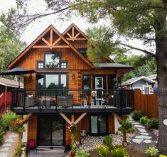 a large wooden house sitting in the middle of a forest