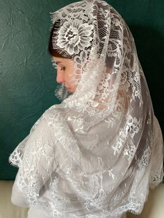 A beautiful triangular chapel veil is made of fine  lace, D shape. Dimensions of the veil: 57 inches from side to side (145 см* 55см) 22 inches front to back The magnificent church is ivory. Lace mantilla veil is processed by beautiful sewing, which gives tenderness and refinement. Lace Mantilla has a triangular shape. Mantilla from a lacy chapel has a light weight. Mantilla can be made in other sizes on request. Mantilla white lace, suitable for the veil, mass, the first holy communion and a gift for the mother. Instructions for use: hand washing and drying on a smooth surface. Do nodt iron. Lace Dupatta With Lace Trim, Lace Work Dupatta For Wedding, Lace Veil With Lace Trim For Ceremonies, Lace Shawl With Lace Trim For Wedding, Lace Ceremony Veil With Lace Trim, Ceremony Lace Veil With Lace Trim, Ceremony Veil With Lace Trim, Wedding Lace Shawl Dupatta, Wedding Lace Dupatta Shawl