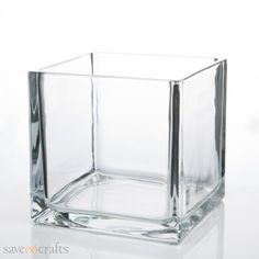 a square glass vase sitting on top of a white table