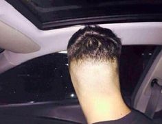 the back of a man's head sitting in a car