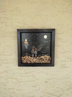 a bird feeder with two birds sitting on it's side in front of a wall