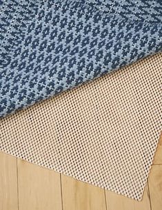 three different types of rugs on the floor in various colors and sizes, including blue