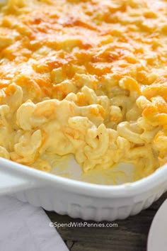 macaroni and cheese casserole in a white dish on a wooden table