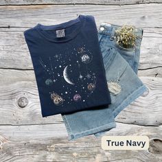 Celestial Moon and Stars Design Woman's Soft and Comfortable T Shirt. These shirts are so comfy you'll never want to take them off. Buy several, so you can have one for every day of the week. If you would like this design in a color than what is offered or on another product, please contact me through Etsy Messages with your request, before placing your order and I will get back with you as soon as possible. Designed in Texas Made In USA ►SHIRT DETAILS: The garment-dyed t-shirt by Comfort Colors Celestial Cotton T-shirt With Crew Neck, Celestial Style Cotton Crew Neck Tops, Celestial Crew Neck Top Relaxed Fit, Celestial Crew Neck Top With Relaxed Fit, Celestial Relaxed Fit Crew Neck Top, Moon Phase Astrology, Vintage Graphic T Shirt, Stars Vintage, Moons And Stars