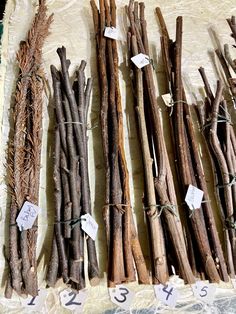 several bundles of sticks on display with price tags attached to them and labeled with numbers