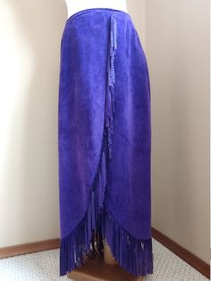 "Great Condition Royal Purple Long Sarong w/Fringe Suede Skirt Brand: Danier Made in Canada Genuine Suede Skirt 100% Acetate Lining Size: 2 Measurements: Waist: 31\" Length including fringe: 35.5\" Hip: 36\" (approx) Overlap at waist: 7\" (sewn in place) Zips in the back with trouser hook and bar closure" Purple Midi Skirt, Mesh Cap, Suede Skirt, Royal Purple, Sarong, Tie Dye Skirt, Milan, Midi Skirt, Womens Skirt