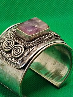 Vintage Metal Cuff With Possible Amethyst Stone Unmarked and Untested  *Used, Secondhand, Vintage and Old Jewelry* Adjustable Purple Bohemian Cuff Bracelet, Bohemian Amethyst Cuff Bracelet Bangle, Purple Amethyst Bohemian Cuff Bracelet, Spiritual Amethyst Cuff Bracelet In Purple, Adjustable Bohemian Amethyst Cuff Bracelet, Spiritual Purple Amethyst Cuff Bracelet, Old Jewelry, Pearl Brooch, Amethyst Stone