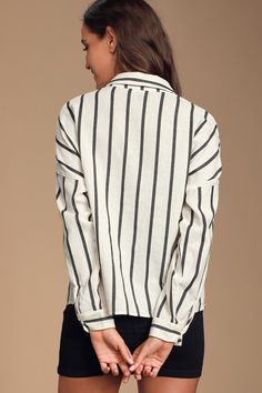 The Lulus Amelia Dawn Off-White Striped Long Sleeve Button-Up Top is perfect for Sunday brunch or Monday in the office! This cotton-blend woven top, covered in vertical black stripes, features long sleeves (with buttoned cuffs) and a collared neckline. Relaxed, straight-cut bodice has a full hidden button placket of tortoise buttons and a patch pocket with contrasting horizontal stripes. Fit: This garment fits true to size. Length: Size medium measures 25.5" from top to bottom. Bust: Great for a Chic White Shirt With Vertical Stripes, Spring Button-up Tops With Horizontal Stripes, Chic Vertical Stripes Shirt For Workwear, Chic Office Shirt With Vertical Stripes, Chic Vertical Stripes Office Shirt, Chic Shirt With Vertical Stripes For Work, Chic Pinstripe Collared Blouse, Spring Office Tops With Vertical Stripes, Spring Office Blouse With Vertical Stripes