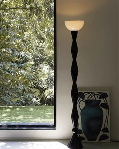 a floor lamp sitting next to a window