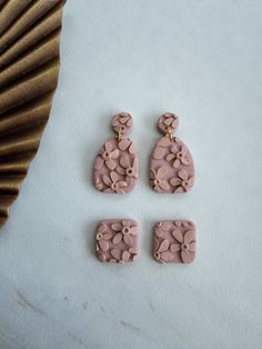 three pieces of pink clay sitting on top of a table