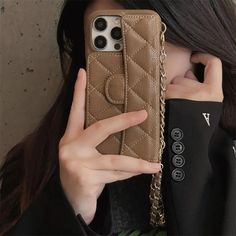 a woman is holding up her phone case