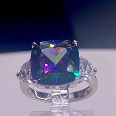 This Beautiful Colorful Cushion Cut Ring Is Est: ( 5 Carats) Rainbow Of Colors Side Stones: Simulated Diamonds 925 Sterling Silver Nwt Boutique 5 Star Rated Closet Elegant Iridescent Rings For Formal Occasions, Luxury Iridescent Jewelry For Formal Occasions, Iridescent Rings With Accent Stones For Formal Occasions, Iridescent Rings With Accent Stones For Formal Events, Silver High Luster Jewelry For Anniversary, Formal Iridescent Rings With Accent Stones, Iridescent Sterling Silver Rings For Formal Occasions, Elegant Iridescent Rings With Accent Stones, Elegant Iridescent Sterling Silver Ring