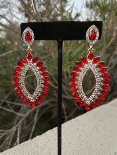 "These fun and stylish red crystal rhinestone earrings are a great statement piece! Size of earrings: 1.25\" Wide  and 2.75\" Long.  Color: red and clear crystal  Base metal: gold Style: pierced and clip on available! More colors available upon request, just message us! Looking for a matching bracelet? https://www.etsy.com/listing/538148439/red-crystal-bracelet-large-crystal?ref=shop_home_active_33 Looking for the perfect pair of earrings for a special occasion. We specialize in custom work in fashion jewelry, pearls, and natural stones! Please feel free to browse through our other listings, and if you can't find what you are looking for just send us a message and will create the perfect piece for you. jewelry.desertrosedesigns.net Expedited shipping available, just contact us!" Red Sparkling Crystal Jewelry, Red Crystal Metal Earrings For Parties, Red Crystal Metal Party Earrings, Red Metal Crystal Party Earrings, Glamorous Red Jewelry With Sparkling Stones, Red Jeweled Metal Earrings, Red Jeweled Earrings For Evening, Red Clip-on Earrings For Party, Red Jeweled Crystal Drop Earrings