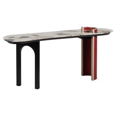 a marble table with red and black legs