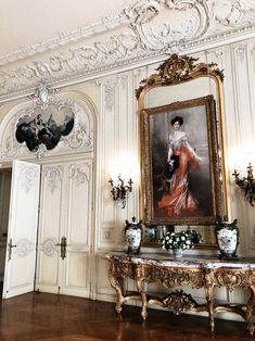 an ornately decorated room with a painting on the wall