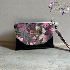 This is a fabulous Wristlet made with a gorgeous floral main fabric accented with bottom and corner design in black crocodile faux leather, with pretty pink leaf print lining on the inside.  Wrist strap is incorporated into the seam.  Pouch is interfaced for sturdiness. Approximate size: 9" wide 6.5" tall no boxed bottom Please spot wipe to clean - do not immerse in water. All items in my shop are manufactured by me in my home shop which is smoke free and one cat friendly. Thank you for supporti Evening Rectangular Wristlet With Wrist Strap, Pouch Wristlet As Gift, Handheld Wristlet With Removable Pouch As Gift, Evening Zipper Pouch Wristlet, Rectangular Clutch With Cell Phone Pocket, Adjustable Wrist Strap Clutch For Everyday Use, Adjustable Zipper Pouch Clutch For Daily Use, Adjustable Clutch With Removable Pouch For Gift, Handheld Wristlet With Zipper Pouch As Gift