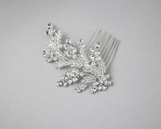 A bright silver crystal wedding hair comb with a style reminiscent of fern fronds. Tiny navette-shaped leaves with petite stones are accented by larger marquise stone clusters along with a few round-cut jewels. silver plated crystal glass stones 4 inches long and 2.5 inches high Fern Frond, Crystal Hair Comb, Hair Comb Wedding