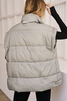 The perfect keeps-you-warm studio-to-street puffer, this water-resistant, satin-finish vest is featured in a bold, oversized style with a slouchy fit. **The Fit:** Oversized, slouchy, relaxed fit, longer-length, higher neckline **The Feel:** Puffy design with a satin, water-resistant finish and 200g-filled design for a warmer feel **The Features:** 2-way zipper, snaps at hem sides for adjustability, space-dye reflective locker loop, logo back neck interior tape, 200g fill power **Best For:** Kee Sleeveless Nylon Puffer Jacket For Spring, Spring Nylon Puffer Vest, Sleeveless Puffer Jacket For Spring, Spring Outdoor Puffer Vest, Spring Puffer Vest For Streetwear, Fall Nylon Vest For Streetwear, Fall Puffer Vest For Streetwear, Trendy Nylon Vest For Fall, Trendy Sleeveless Winter Puffer Jacket