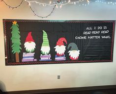 a bulletin board with gnomes on it and christmas lights hanging from the ceiling above