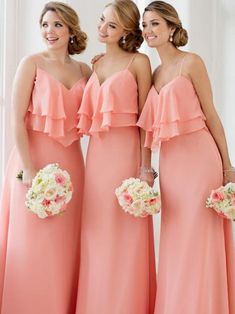 three bridesmaids in pink dresses posing for the camera