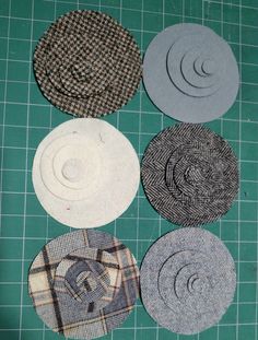 four different types of hats laid out on a green cutting board with scissors and thread